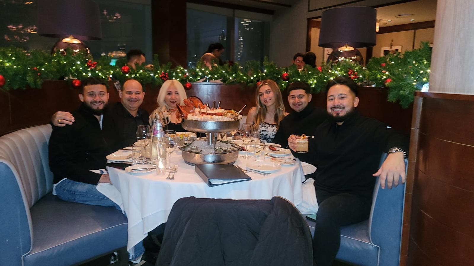 Steven's family gathered around a dinner table in Queens